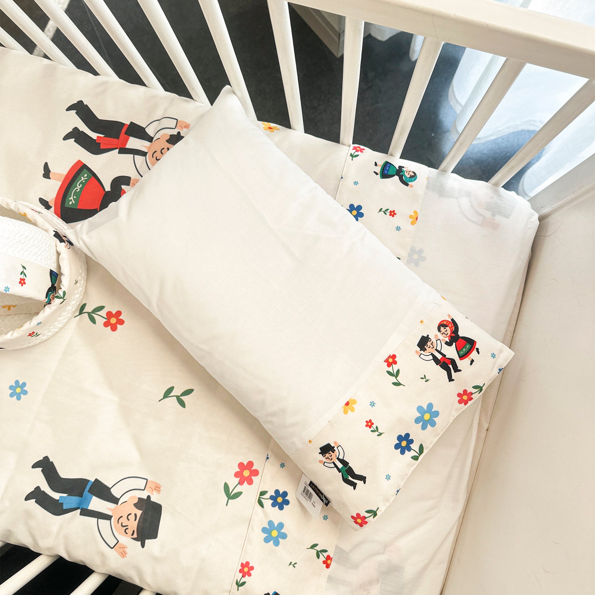 Pillow cover with "Playing Pilgrimage" appliqué.